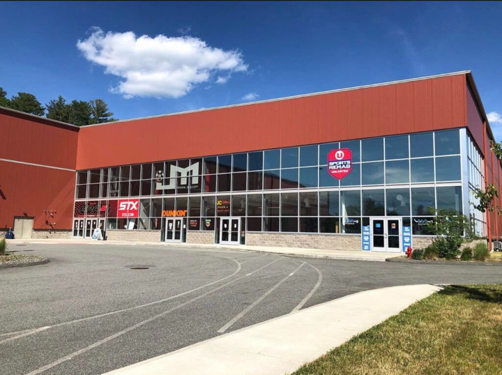 Red building with glass facade and signs